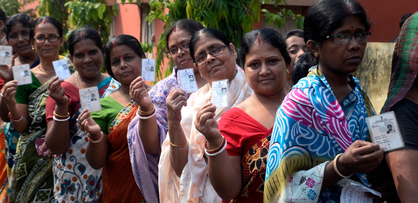 Indian,Women,Stand,In,Queue,With,Their,Voter,Id,Card